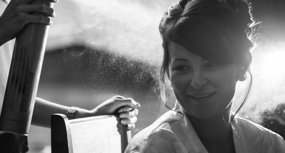 The bride preparing her hair on her wedding day.