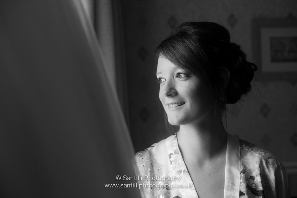 The bride taking a moment before her wedding dress to ponder on the happy times to come.