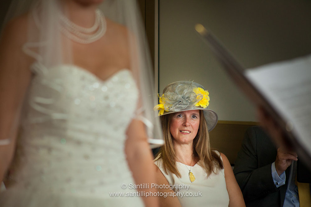 The bride's very proud mother lookin on during the wedding ceremony.