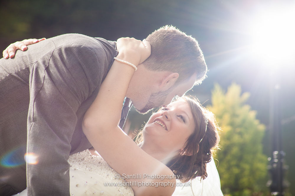 The groom holding his new wife ready to kiss her