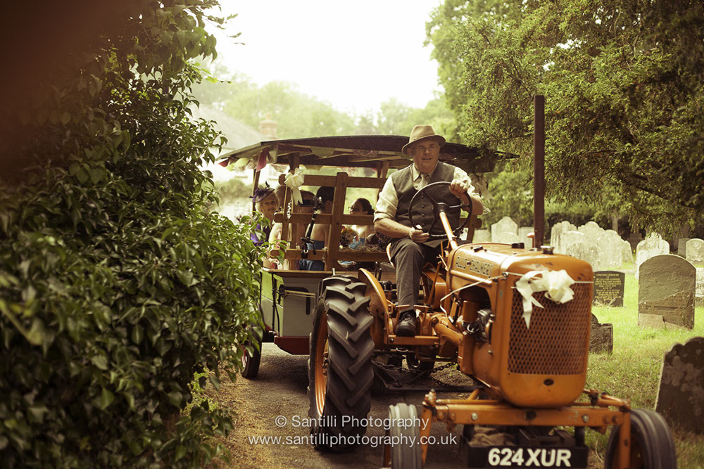 The bridal party is coming in her vintage tractor and beautifly decorated cart